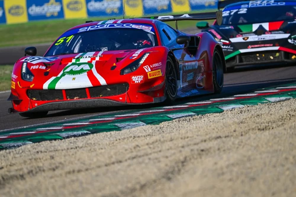 Red race car driving through a corner on the racetrack